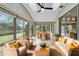 A cozy sunroom with wicker furniture, tile floors, and great backyard views at 7 Arbor Oaks Dr, Sarasota, FL 34232
