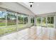 Beautiful sunroom featuring tiled floor, large windows with views of the backyard at 7 Arbor Oaks Dr, Sarasota, FL 34232