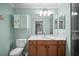 This is a bathroom with blue walls, a wooden vanity, and a glass shower at 7005 River Hammock Dr # 206, Bradenton, FL 34212