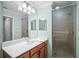 Bathroom featuring a single sink vanity and a glass-enclosed walk-in shower at 7005 River Hammock Dr # 206, Bradenton, FL 34212
