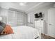 Cozy bedroom featuring a white bedspread, closet, ceiling fan, and a wall-mounted television at 7005 River Hammock Dr # 206, Bradenton, FL 34212