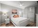 Comfortable bedroom featuring a ceiling fan, hardwood floors, a closet, and soft lighting at 7005 River Hammock Dr # 206, Bradenton, FL 34212
