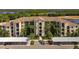 Beautiful condo community with a tile roof, lush landscaping, and covered parking at 7005 River Hammock Dr # 206, Bradenton, FL 34212