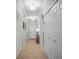 Bright hallway featuring tile flooring, neutral paint, and multiple storage closets at 7005 River Hammock Dr # 206, Bradenton, FL 34212