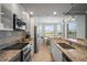 Contemporary kitchen featuring granite countertops, stainless appliances, and a sunny breakfast nook at 7005 River Hammock Dr # 206, Bradenton, FL 34212
