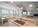 Bright open kitchen featuring an eat-in bar, views of a golf course, and a breakfast nook at 7005 River Hammock Dr # 206, Bradenton, FL 34212