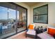 Comfortable lanai seating, sliding glass door entry, and view of the lake at 7005 River Hammock Dr # 206, Bradenton, FL 34212