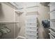 This walk-in closet has built in storage solutions with shelves and basket drawers at 7005 River Hammock Dr # 206, Bradenton, FL 34212