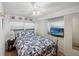 Cozy bedroom with a ceiling fan and built in storage for organizing personal belongings at 720 S Green Cir, Venice, FL 34285