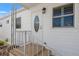Charming front entrance with a decorative glass door, sidelight and well-maintained staircase at 720 S Green Cir, Venice, FL 34285