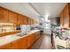 Spacious kitchen features stainless steel appliances, ample cabinetry, and durable brick flooring at 720 S Green Cir, Venice, FL 34285