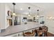 This well-equipped kitchen features stainless steel appliances, white cabinets, and a large countertop seating area at 720 S Green Cir, Venice, FL 34285