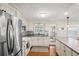Bright kitchen features stainless steel appliances, white cabinetry, mosaic backsplash, and durable countertops at 720 S Green Cir, Venice, FL 34285