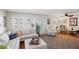Inviting living room features a comfortable seating area, a front door, and plenty of natural light with plantation shutters at 720 S Green Cir, Venice, FL 34285