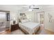 Comfortable main bedroom featuring a ceiling fan, en suite bathroom, and walk-in closet at 720 S Green Cir, Venice, FL 34285