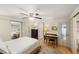 Comfortable main bedroom with ceiling fan plus a separate desk, en suite bathroom, and walk-in closet at 720 S Green Cir, Venice, FL 34285