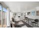 Bright sunroom with tile flooring and comfortable seating area with view to the outside at 720 S Green Cir, Venice, FL 34285