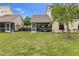 Backyard features a screened in porch with green grass and lush plants at 7637 Sweetbay Cir, Bradenton, FL 34203