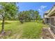 The backyard is spacious and has beautiful trees and lush green grass at 7637 Sweetbay Cir, Bradenton, FL 34203