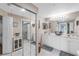 Spacious bathroom with double sinks, framed mirrors, and a glass door shower at 7637 Sweetbay Cir, Bradenton, FL 34203