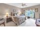 Comfortable bedroom showcasing a queen bed and a window with scenic views at 7637 Sweetbay Cir, Bradenton, FL 34203