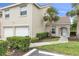 Inviting home exterior showcasing a well-manicured lawn, a two-car garage, and palm trees at 7637 Sweetbay Cir, Bradenton, FL 34203