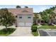 Attractive exterior of a multi-unit building with attached garages and well-maintained landscaping at 7637 Sweetbay Cir, Bradenton, FL 34203