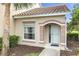 The front entrance of the home features a white door, beige trim, and a view of the yard at 7637 Sweetbay Cir, Bradenton, FL 34203