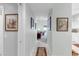 Inviting hallway with tile floors, framed artwork, and a view into the living area at 7637 Sweetbay Cir, Bradenton, FL 34203