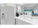Clean, bright kitchen with a view through to the lanai beyond the sink at 7637 Sweetbay Cir, Bradenton, FL 34203