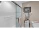 Modern tiled shower featuring a glass door and chrome fixtures for a clean look at 7637 Sweetbay Cir, Bradenton, FL 34203