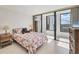Bedroom with tile floor and large windows with view to the outside at 770 Palm Avenue # 903, Sarasota, FL 34236