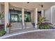 Welcoming entrance to building with landscaped planters and stairway at 770 Palm Avenue # 903, Sarasota, FL 34236
