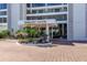 Building entrance with circular drive and elegant landscaping at 770 Palm Avenue # 903, Sarasota, FL 34236