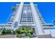 Exterior view of Embassy House, featuring a tall, modern condo building with lush landscaping at 770 Palm Avenue # 903, Sarasota, FL 34236