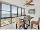 Bright dining area with large windows and views of the city skyline and bay at 770 Palm Avenue # 903, Sarasota, FL 34236