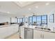 Open concept kitchen with a double sink and panoramic water views in the background at 770 Palm Avenue # 903, Sarasota, FL 34236