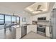 Modern kitchen with stainless steel appliances, sleek countertops, and a dining area overlooking the water at 770 Palm Avenue # 903, Sarasota, FL 34236