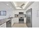 Modern kitchen with stainless steel appliances, white cabinetry, and recessed lighting at 770 Palm Avenue # 903, Sarasota, FL 34236