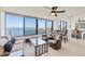 Inviting living room with expansive windows showcasing waterfront views and ample natural light at 770 Palm Avenue # 903, Sarasota, FL 34236