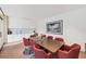 Bright meeting room with modern table, red chairs, and kitchenette with white cabinetry at 770 Palm Avenue # 903, Sarasota, FL 34236