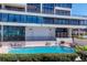 Exterior view of building and community pool with seating and lush hedges at 770 Palm Avenue # 903, Sarasota, FL 34236