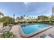 Inviting community pool surrounded by lush landscaping and palm trees with beach views at 770 Palm Avenue # 903, Sarasota, FL 34236
