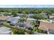 Aerial view highlighting a home with a screened-in pool, set amidst a lush, green neighborhood at 7984 Glenbrooke Ln, Sarasota, FL 34243