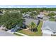 Aerial view of a charming home with a screened-in pool and lush landscaping in a serene neighborhood at 7984 Glenbrooke Ln, Sarasota, FL 34243