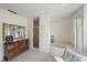 Cozy bathroom featuring a tub, separate shower, and a wood dresser at 7984 Glenbrooke Ln, Sarasota, FL 34243