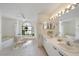 Bright bathroom with double vanity, lots of light, and a soaking tub at 7984 Glenbrooke Ln, Sarasota, FL 34243