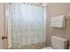 Bathroom features a shower/tub combo with geometric pattern curtain at 7984 Glenbrooke Ln, Sarasota, FL 34243