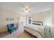 Cozy bedroom featuring a ceiling fan, comfortable bed, chair, and dresser at 7984 Glenbrooke Ln, Sarasota, FL 34243