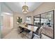 Light and airy dining room features stylish table, chairs and a decorative light fixture at 7984 Glenbrooke Ln, Sarasota, FL 34243